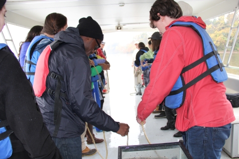 ecology school on pontoon boat holding rope