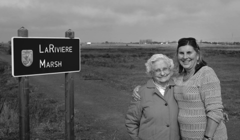 a black and white photo of two women outside