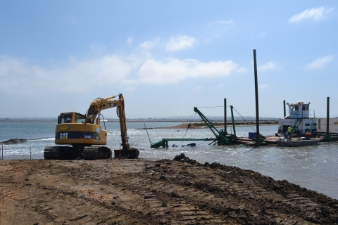 The excavator on the left moved earth while the dredge on the left, carved a smoother channel at precise elevations.