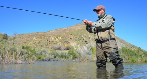 a man in a lake fishing