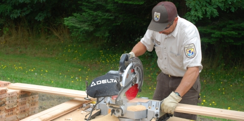 Quilcene National Fish Hatchery staff cutting lumber for maintenance project.