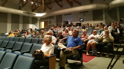 People seated in an auditorium.