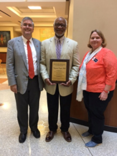 Dr. George Perry, Dean of the College of Sciences, Dr. Tuggle, and Dr. Janis Bush, Department Chair, Dept. of Environmental Science and Ecology, join Dr. Tuggle after he accepted the award presented by UTSA students to express their appreciation to the U.S. Fish and Wildlife Service.
