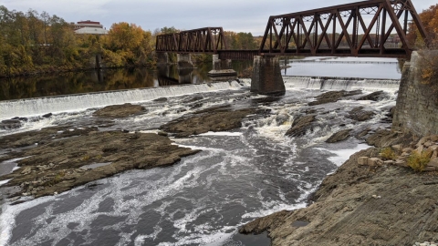 bridge and dam over flowing river