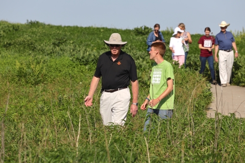 Intern and visitor chatting along a prairie trail