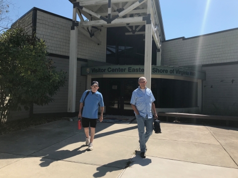 Two volunteers walking out of the visitor center at Eastern Shore of Virginia Refuge