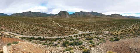 Ultrawide angle photo from above of a dirt road in the desert