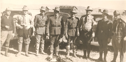 1930s Game Wardens stand in front of a dead bird.