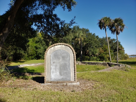 Shell foundation remains of the Old Fort with stone monument to first settlers places in front of remains, Cape Romain NWR