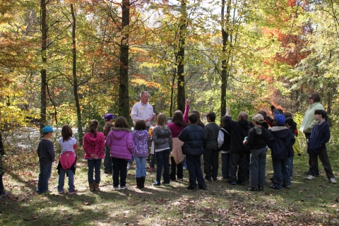 Educator talking to school group outside Visitor Center