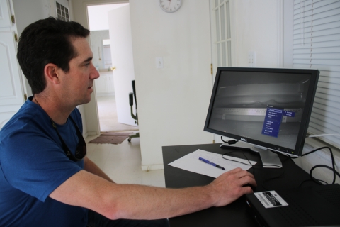 Man in front of computer monitor black and white camera lamprey tube