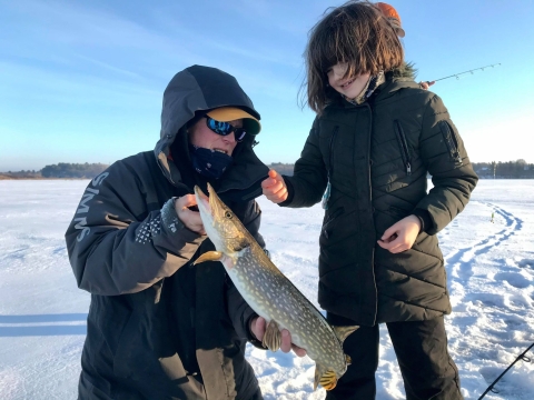 girl and man with a long fish