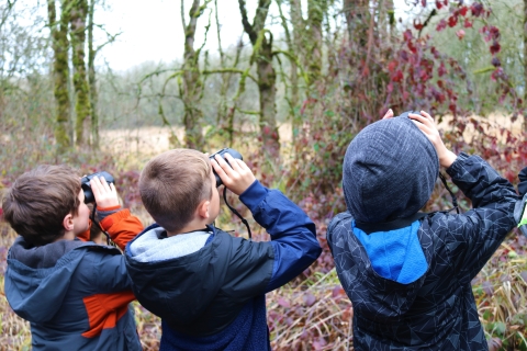 Three boys with binoculars