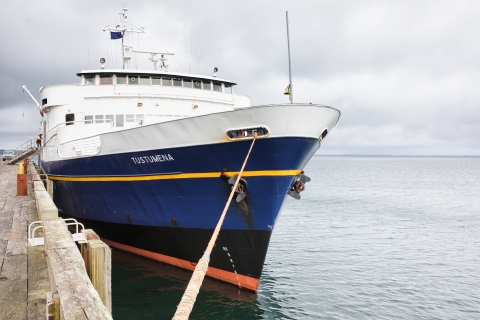 Blue and white ship with name Tustumena on the bow