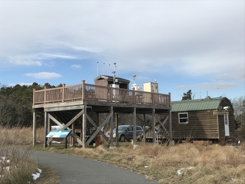 An air monitoring station sits upon a wooden platform along the Grassland trail at Edwin B. Forsythe refuge headquarters.