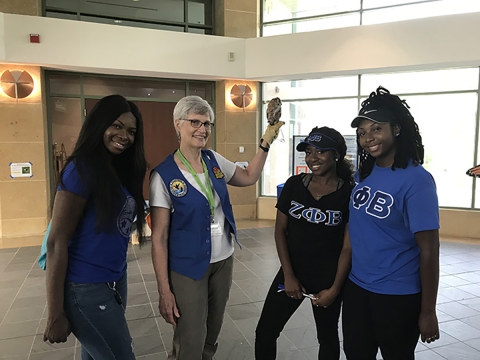 Zeta Phi Beta Members Cynthia Ofosu, Sierre Snyder and Kelsey Burks with a screech owl and Service Handler