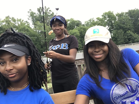 Zeta Phi Beta Sorority, Inc. members Kelsey Burks, Sierra Snyder and Cynthia Ofosu portrait photo at a pier. 