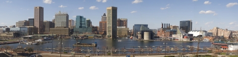 an urban skyline with clusters of skyscrapers in the distance