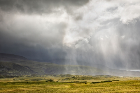 Storm clouds dump rain on fall tundra