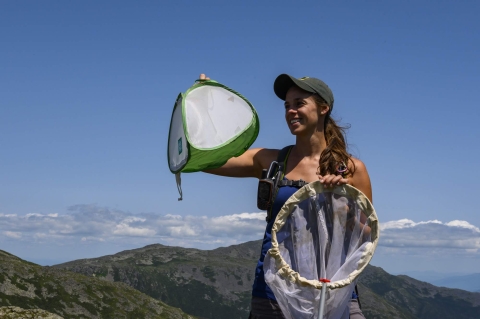 Smiling woman holding up net