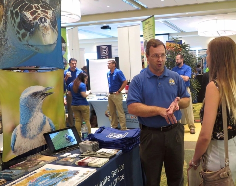 man talks to person at career fair