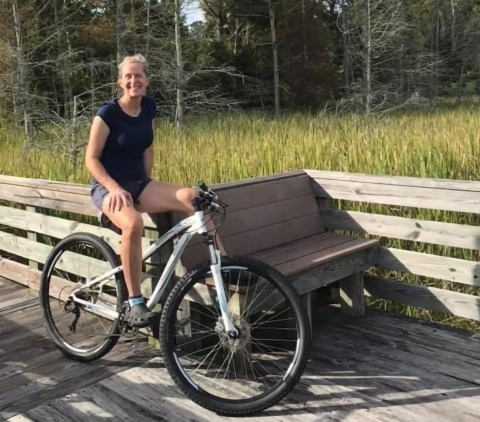 Person sitting on bicycle.