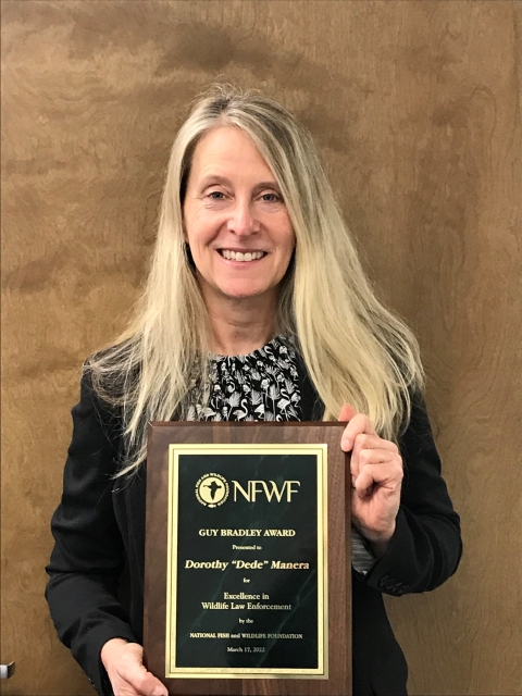 Person holding an award plaque.