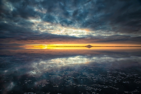 A sunset over Izembek Lagoon with a cloudy sky reflecting over the water