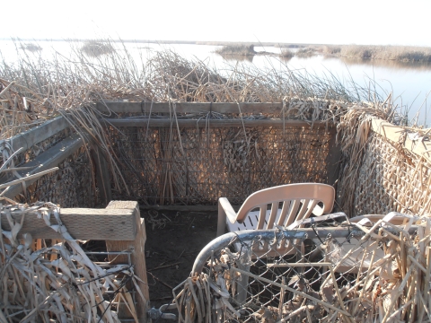 view of inside of hunt blind showing 2 plastic chairs