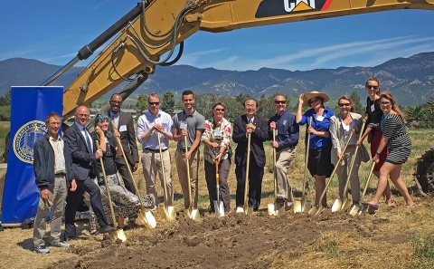 A group of people holding shovels