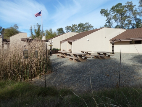 Picture of the picnic area with tables and birdfeeders at the Sacramento NWR Visitor Center