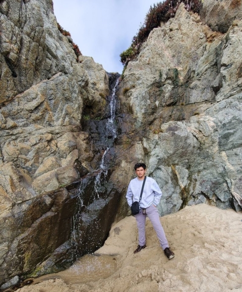 Armando in front of a waterfall