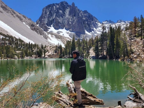 Armando at Big Pines Lake featuring a lake and snow capped mountains