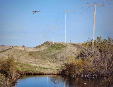 view of airplane flying over the landscape