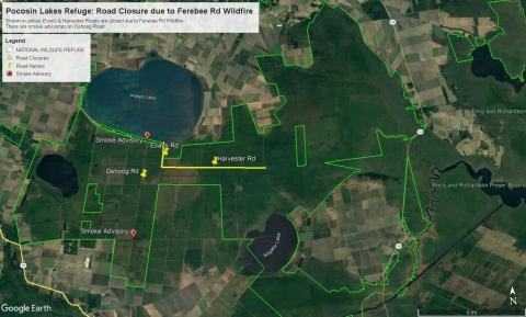 A satellite map of Pocosin Lakes showing the refuge boundary, as well as road closures in yellow and red pins marking smoke advisories. Two roads in the central part of the refuge, Evan's and Harvester, are highlighted and marked as closed. In addition, DeHoog Road from Shore Drive to 5.5 miles south is under a smoke advisory.