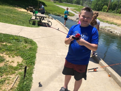 boy with a fish he has caught