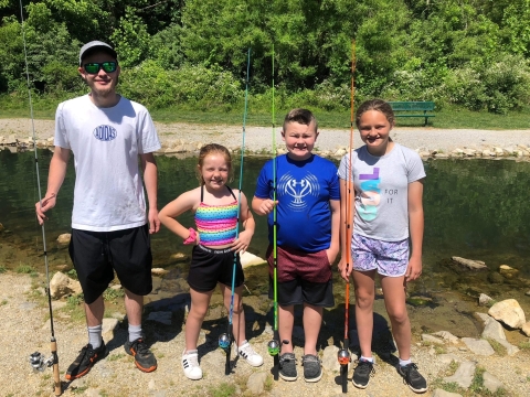 children with fishing poles