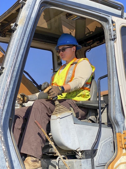 a woman operation a piece of heavy equipment