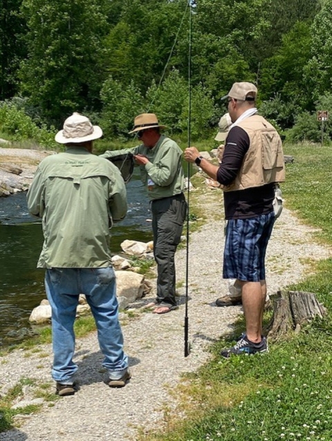 Group of men fly fishiing