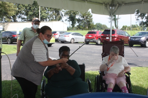 Nursing home resident reeling in a fish.