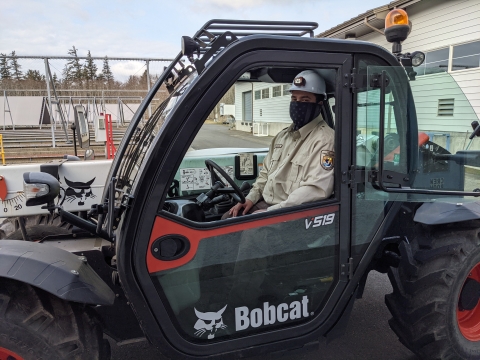 Makah National Fish Hatchery employee, Thomas Johnson, operating a forklift.