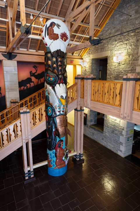 Totem Pole displayed in front of wood carved steps