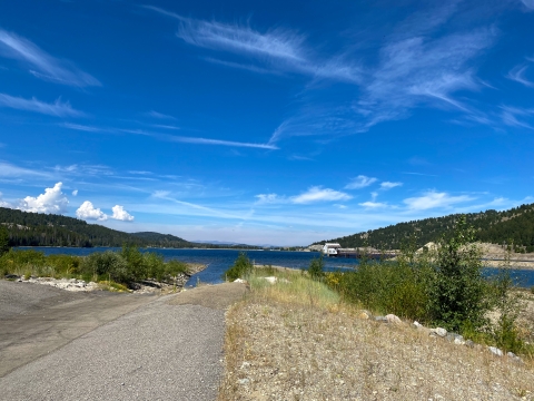 Open area with a gravel path leading to a river 