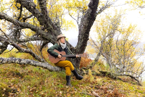 musician KT Tunstall plays guitar in a tree