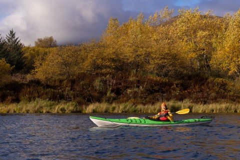 a woman in a kayak on a lake