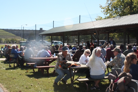 Seniors relaxing at picnic tables.