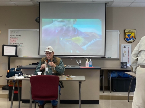 Man giving fly-tying demonstration