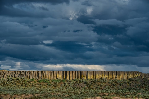 The remnants of a basalt lava flow sits beneath a heavily clouded sky