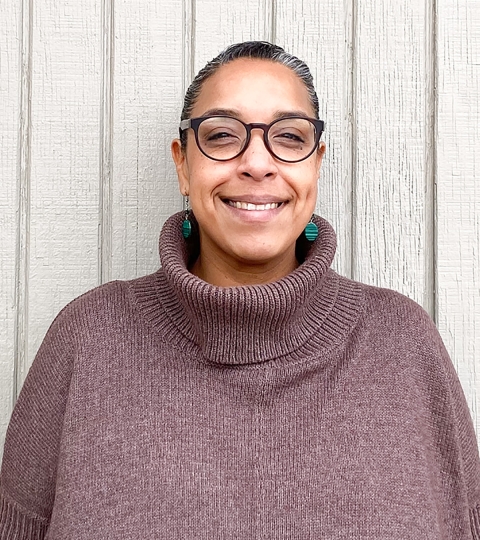 portrait of Carina Ruiz wearing glasses and smiling