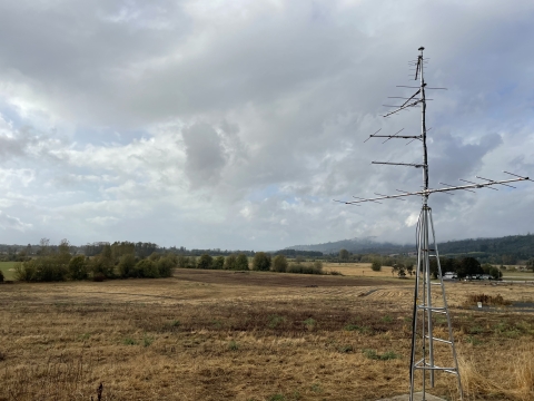 Motus tower in foreground in field at Ankeny National Wildlife Refuge